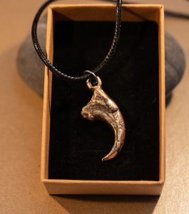 bronze cast velociraptor claw pendant