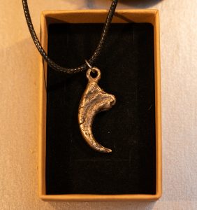 bronze cast velociraptor claw pendant