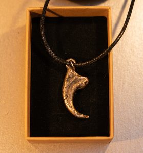 bronze cast velociraptor claw pendant