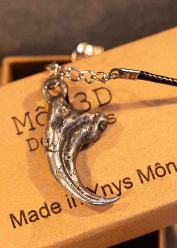 Hand sculpted and hand cast Velociraptor claw as a pendant, sculpted and cast in lead free Pewter